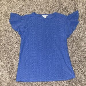 blue top with ruffled sleeves